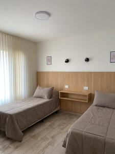a bedroom with two beds and a window at Rockaway Apart in Miramar +46 photos