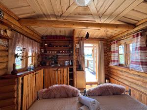 a log cabin with two beds in a room at Metsakuurorti puhkekeskus, Kunksmoor house in Väike-Särge