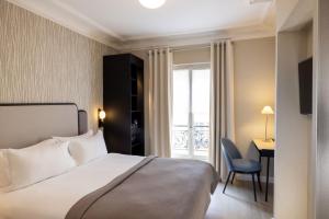 a bedroom with a bed and a desk and a window at Hotel le 46 R&eacute;novation 2024 in Paris