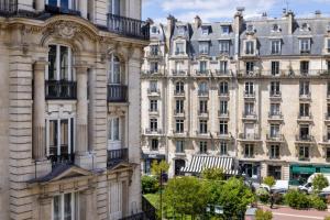 an apartment building in paris viewed from the street at Hotel le 46 in Paris
