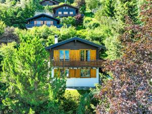 una casa in cima a una collina con alberi di Chalet Magicien by Interhome a Nendaz