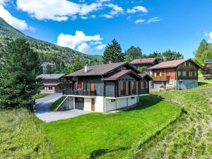 an aerial view of a house with a green yard at Chalet Peer Gynt by Interhome in Nendaz