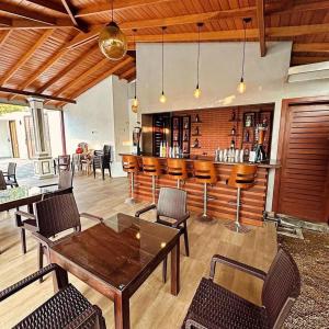 a dining room with a bar and a table and chairs at Sunset Villa in Waskaduwa