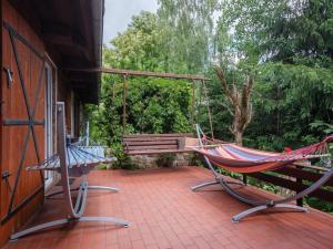 a hammock and a bench on a patio at Holiday Home Perła by Interhome in Trygort