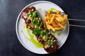 a plate of food with meat and french fries at Fiesta Royale Hotel in Accra