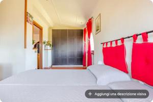 a bedroom with a large bed with red pillows at I like Chopin apartments in Fiumicino
