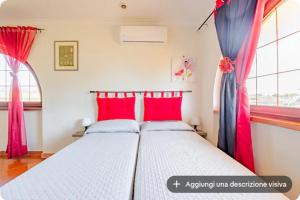 a bedroom with a bed with red and blue curtains at I like Chopin apartments in Fiumicino