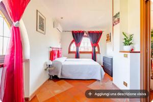 a bedroom with a bed with red drapes at I like Chopin apartments in Fiumicino