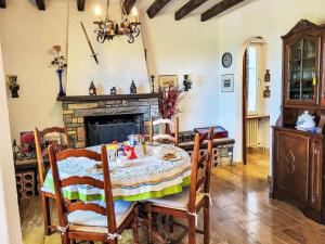 a dining room with a table and a fireplace at Holiday Home Casa Naima by Interhome in Breno