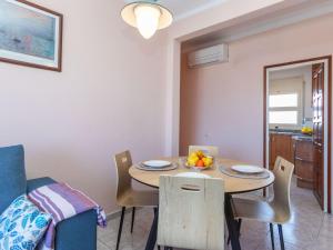 a kitchen and dining room with a table and chairs at Apartment Fénix Marina by Interhome in L'Escala