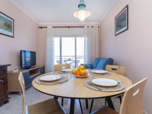 a dining room with a table with fruit on it at Apartment Fénix Marina by Interhome in L'Escala