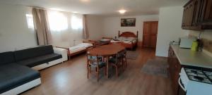 a kitchen and living room with a table and a couch at Gecse-Villa in Sárospatak