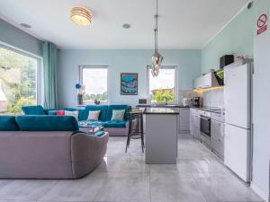 a kitchen and living room with a couch and a refrigerator at Holiday Home Butterfly Lux by Interhome in Dobra