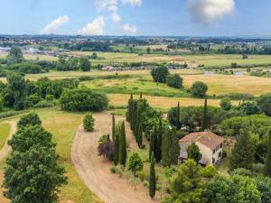 an aerial view of a house in a field with cypress trees at Holiday Home Tenuta La Colonna by Interhome in Ponte di Masino