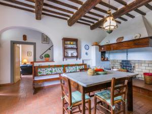 a living room with a table and chairs and a couch at Holiday Home Tenuta La Colonna by Interhome in Ponte di Masino