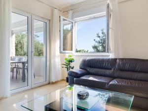 a living room with a leather couch and a glass table at Holiday Home Relax by Interhome in Jasenice