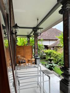 a patio with a table and chairs on it at Jana's Homestay in Sidemen