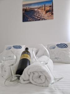 a bed with a bottle of wine and a towel at B&L Apartments in Vir +7 photos