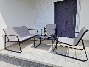 two chairs and a table on a patio at B&L Apartments in Vir