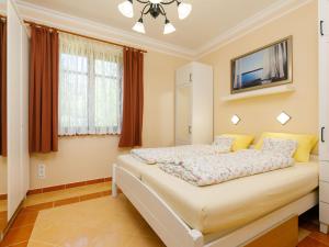 a bedroom with a bed and a tv on the wall at Holiday Home Elisabeta Grande by Interhome in Balatonőszöd