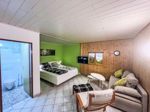 a living room with a couch and a bed at Holiday Home LuxuSölk-5 by Interhome in Stein an der Enns