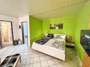 a bedroom with a bed in a green wall at Holiday Home LuxuSölk-5 by Interhome in Stein an der Enns
