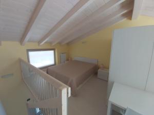 a small bedroom with a bed and a staircase at Casa ai due Laghi in Fonteno
