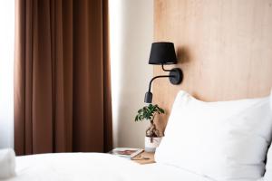 A bed or beds in a room at Hotel Liberec