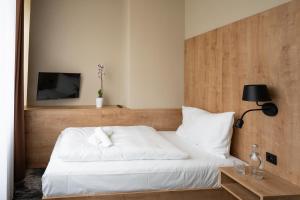 A bed or beds in a room at Hotel Liberec