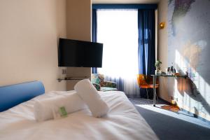 A bed or beds in a room at Hotel Liberec