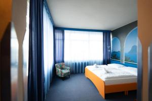 A bed or beds in a room at Hotel Liberec
