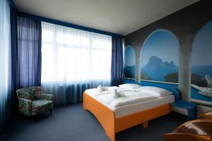 A bed or beds in a room at Hotel Liberec
