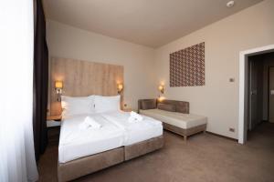A bed or beds in a room at Hotel Liberec