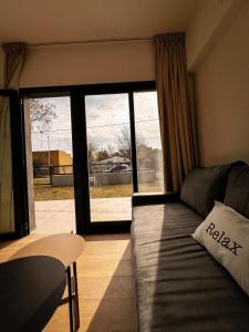 a living room with a couch and a large window at La Casita Lezama in Manuel J. Cobo +4 photos