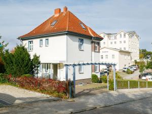 a white house with an orange roof at Apartment Melchien 2 by Interhome in Zinnowitz
