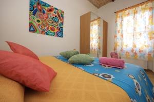 a bedroom with a bed with pillows on it at Casa Dalu nel centro di Ostia Antica in Ostia Antica