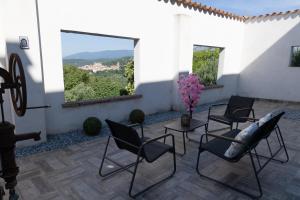 a patio with chairs and a table with a view at Moulin du désir in Montauroux