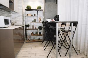 a kitchen with a table and chairs in a room at 47 Steps in Rome