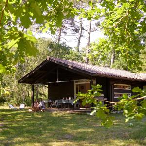 a house with people sitting in front of it at Villa Marina de Talaris, Lacanau in Lacanau +24 photos