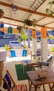 a patio with a table and chairs and a boat at Pousada Sete Mares Manaira in João Pessoa