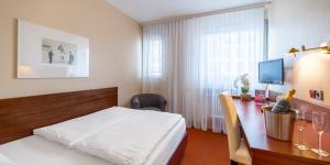 Ліжко або ліжка в номері PLAZA INN Rieker Stuttgart Hauptbahnhof