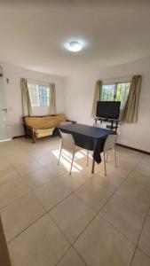 a living room with a table and a piano at Casa En Victoria Entre Ríos Salida Al Rio Pesca Cabaña in Victoria