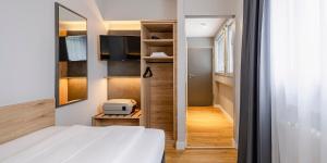 Ліжко або ліжка в номері PLAZA INN Rieker Stuttgart Hauptbahnhof
