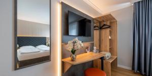 Ліжко або ліжка в номері PLAZA INN Rieker Stuttgart Hauptbahnhof