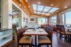a dining room with a table and chairs at Treebo Maharaja, Near Mall Road in Shimla