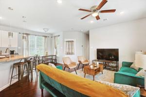 a living room with a couch and a table at 4BR 2,5BA Holiday Home in the Heart of Cowboy Nation in Arlington