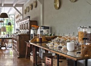 a kitchen with a large table with dishes on it at HMO Glamping & Suites in Vignanotica in Mattinata