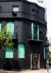 a black building with two balconies on it at Art Factory Soho in Buenos Aires
