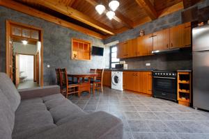 a kitchen with a couch and a table in it at Adega Menezes in Lajido