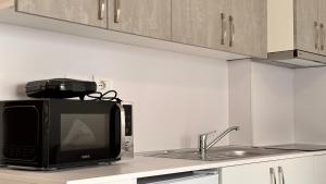 a microwave oven sitting on top of a kitchen counter at Sublime studio nr3 in Ulcinj